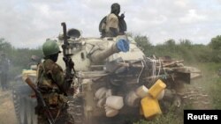 African Union Mission (AMISOM) forces patrol after fighting between insurgents and government soldiers on the outskirts of Mogadishu, Somalia, May 22, 2012. 