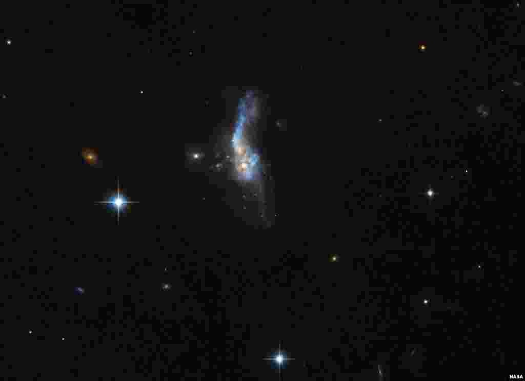 This celestial object called IRAS 14348-1447 is actually a combination of two gas-rich spiral galaxies. It is located over a billion light-years away from us. It is one of the most gas-rich examples known of an ultraluminous infrared galaxy, a class of cosmic objects that shine characteristically — and incredibly — brightly in the infrared part of the spectrum. The image was taken by Hubble’s Advanced Camera for Surveys.