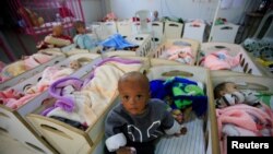 FILE - Children of Islamic State fighters are seen at a hospital in Hasaka, northeastern Syria, April 6, 2019.