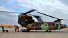 In this Jan. 13, 2020, photo, a U.S. Air Force helicopter sits at Ain al-Asad air base, in Anbar, Iraq. The U.S.-led coalition pulled out from a base in the country's west as part of plans to drawdown on March 19, 2020, amid fears of a viral pandemic. 
