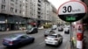FILE - Cars pass by a speed limit sign displaying a "Thank you," on a street in Berlin, Germany, May 20, 2019. 