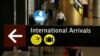 FILE - A sign for International Arrivals is shown at the Seattle-Tacoma International Airport in Seattle, June 26, 2017.