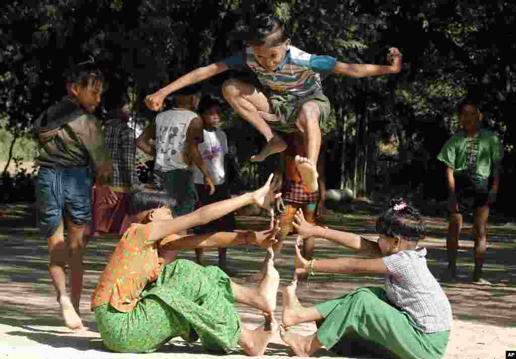 Children with traditional hair style play at the monastery compound in Set-Set-Yo village near old Bagan, Nyaung U district, central Myanmar.