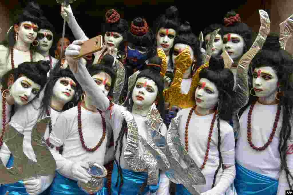 Indian schoolchildren dressed as Hindu God Lord Shiva pose for a 'selfie' ahead of their performance during an annual school function in Amritsar.
