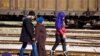A Syrian family walk back down the tracks away from Macedonia after being told the border won’t open today. (Jamie Dettmer for VOA)
