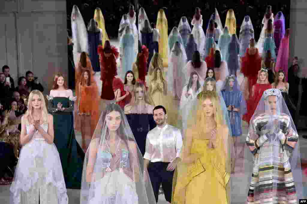 Fashion designer Alexis Mabille (C) acknowledges the audience at the end of the 2017 spring/summer Haute Couture collection in Paris, France.