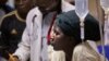 A woman cradles the head of a young patient injured in a grenade attack at a downtown bus station, at Kenyatta Hospital in Nairobi, Kenya, March 10, 2012. 