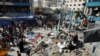 Palestinians gather at the site of an Israeli air strike on a UN school sheltering displaced people, amid the Israel-Hamas conflict, in Nusairat in central Gaza Strip, July 14, 2024. 