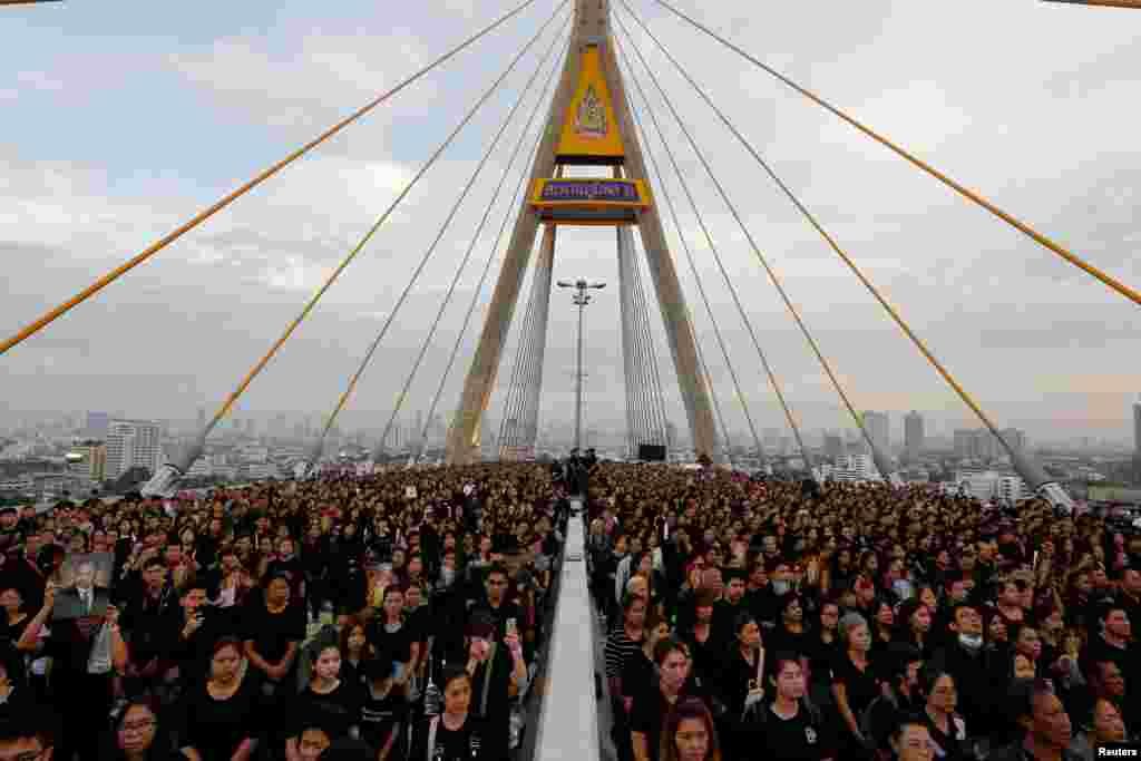 People gather at Bhumibol Bridge over Chao Phraya river in Bangkok, Thailand, to mark late King Bhumibol Adulyadej&#39;s birthday.