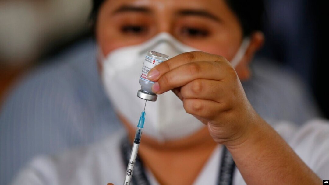 A nurse prepares a syringe with the Moderna COVID-19 vaccine at a temporary hospital in Guatemala City, Feb. 25, 2021. 