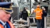 Police and other emergency workers stand in front of the damaged Zaventem Airport terminal in Brussels on March 23, 2016. 