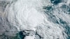 FILE - A satellite image made available by the U.S. National Oceanic and Atmospheric Administration shows a tropical storm approaching the South Carolina coast, May 27, 2020.