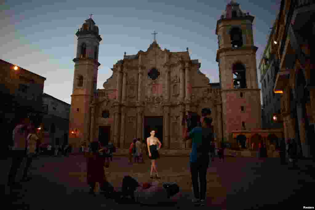 Yazuli Lloret, 15, poses for a photographer at the Cathedral Square in Havana, Cuba, Dec. 27, 2016.
