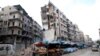 FILE - Stalls are seen on a street beside damaged buildings in the rebel held al-Shaar neighborhood of Aleppo, Syria, Feb. 10, 2016. 