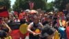 People carry Australian Aboriginal flags during a demonstration on Australia Day in Sydney, Jan. 26, 2019.