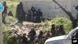 This image posted on the Twitter page of Syria's al-Qaida-linked Jabhat al-Nusra, April 25, 2015, shows Nusra fighters in the town of Jisr al-Shughour, Idlib province, Syria.