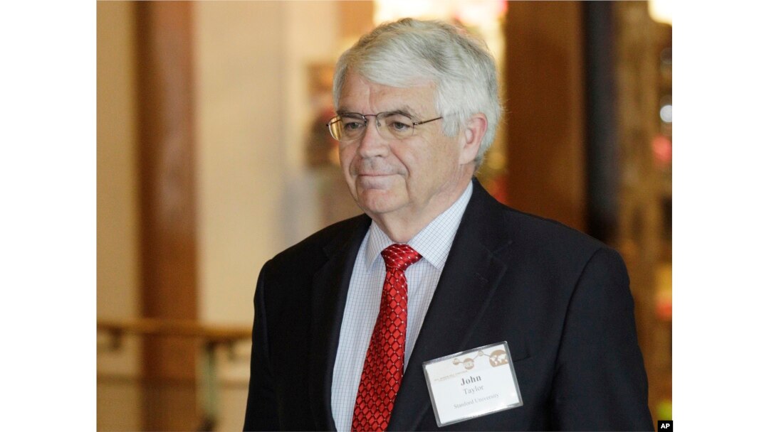FILE - John Taylor, of Stanford University, arrives for a dinner at the Jackson Hole Economic Symposium near Jackson Hole, Wyo., Aug. 30, 2012.