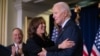 U.S. Vice President Kamala Harris embraces U.S. President Joe Biden prior to speaking during the Democratic National Committee's Holiday Reception in Washington, D.C., Dec. 15, 2024.