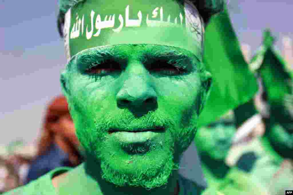 A Muslim shows off his colored face during a gathering marking the birth anniversary of Islam's Prophet Mohammed, in capital city Sana'a, Yemen, Dec. 11, 2016.