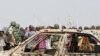 Clergymen gather around the coffins of the victims of the Christmas day bombing at St Theresa Catholic Church Madalla, during a mass funeral for the victims. Boko Haram claimed responsibility for the attack.