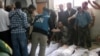 Handout photo released by Syrian opposition's Shaam News Network shows UN observers at hospital morgue before their burial in central Syrian town of Houla on May 26, 2012.