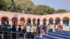 Voters line up to cast ballots at a school where voting booths were set up in New Delhi for choosing a new local government, New Delhi, India, Feb. 8, 2010. (A. Pasricha/VOA)