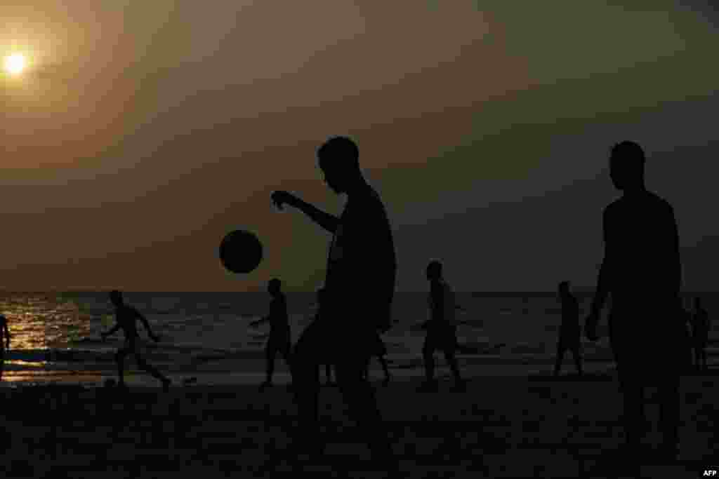 People plays soccer at sunset at the beach in Libreville, Gabon. Libreville is holding the African Cup of Nations Final match on Sunday between Egypt and Cameroon, at the Stade de l'Amitie.