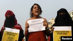 FILE - Women hold placards and shout slogans during a protest in solidarity with rape victims and to oppose violence against women in Mumbai, India, Dec. 8, 2019.