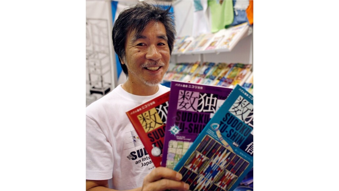 FILE - 'Father of Sudoku' Maki Kaji holds copies of the latest sudoku puzzles at the Book Expo, in New York, June 3, 2007.