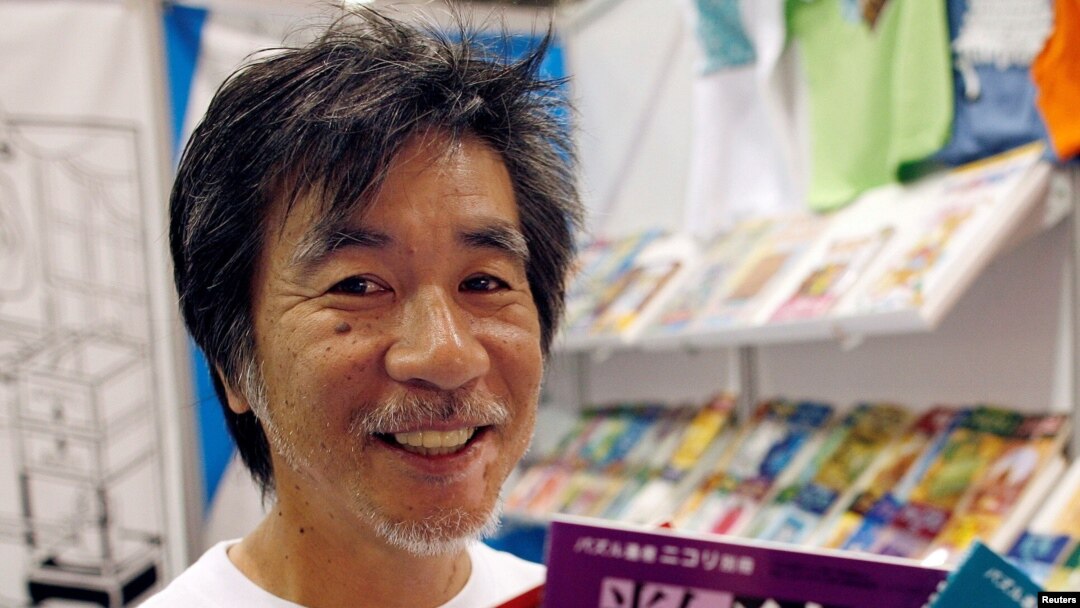 FILE - 'Father of Sudoku' Maki Kaji holds copies of the latest sudoku puzzles at the Book Expo, in New York, June 3, 2007. 