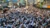People take part in a protest rally to condemn the killing of a school van driver by a gunman in a Monday attack and demanding the immediate arrest of the attacker, in Mingora, Swat Valley, Pakistan, Oct. 11, 2022. 