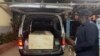 A wooden coffin containing the body of Pakistani journalist Arshad Sharif is loaded into a van at the Chiromo mortuary in Nairobi, Kenya, Oct. 24, 2022. 