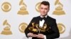 Sam Smith poses in the press room with the awards for best new artist, best pop vocal album for “In the Lonely Hour”, song of the year for “Stay With Me”, and record of the year for “Stay With Me” at the 57th annual Grammy Awards at the Staples Center on 