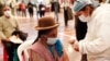 A woman gets a shot of the Sinopharm COVID-19 vaccine during vaccinations of people over age 40 inside the gym of the American Institute school in La Paz, Bolivia, June 4, 2021.