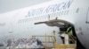 FILE - A worker looks on as the second delivery of the Johnson & Johnson COVID-19 vaccine is offloaded at the O.R Tambo International Airport in Johannesburg, South Africa, Feb. 27, 2021. (Kim Ludbrook/Pool via Reuters)