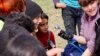 A volunteer paints the nails of refugees in Idomeni on the Greek-Macedonian border. (J. Dettmer/VOA)