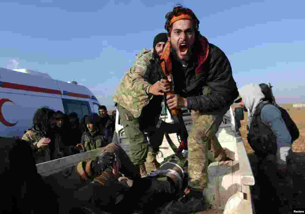 A Free Syrian Army (FSA) fighter reacts as he mourns near the body of his brother, who was an FSA fighter and died during an offensive against Islamic State fighters to take control of Qabasin town, on the outskirts of the northern Syrian town of al-Bab.