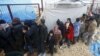 Internally displaced Syrians line up to receive blankets near the Bab al-Salam crossing, across from Turkey's Kilis province, on the outskirts of the northern border town of Azaz, Syria, Feb. 6, 2016. 