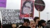 A Turkish woman holds a poster of murdered 20-year-old student Ozgecan Aslan at a protest in Ankara Feb. 18, 2015. The placards read: "End the killings of women" and "Islam (Aysenur Islam, Family Affiars minister), did you hear Ozgecan's scream?"
