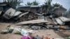 FILE - Burnt-down houses are seen following an attack allegedly perpetrated by the Allied Democratic Forces, in the village of Manzalaho near Beni, Democratic Republic of Congo, Feb. 18, 2020. ADF is accused of multiple deadly attacks in the area. 