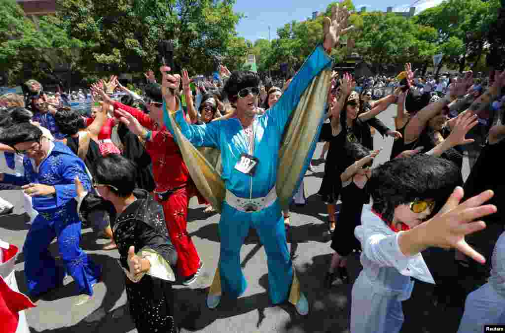 Children and adults dressed as Elvis Presley participate in a street parade at the 25th annual Parkes Elvis Festival in the rural Australian town of Parkes, west of Sydney, Australia, Jan. 14, 2017.