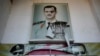 A torn poster shows ousted Syrian President Bashar al-Assad at the entrance of a detention center in Damascus, Syria, Dec. 14, 2024.