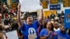 A pro-immigration reform demonstrator yells at U.S. President Barack Obama during a campaign rally for Maryland Lt. Gov. Anthony Brown in Upper Marlboro, Maryland, Oct. 19, 2014.