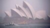 Heavy clouds cover Sydney Harbor, Nov. 28, 2018. Flights were cancelled, railway lines closed and motorists stranded on flooded roads as a month's worth of rain fell on Sydney.
