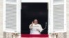 Pope Francis waves during the Angelus noon prayer from the window of his studio overlooking St. Peter's Square, at the Vatican, Sept. 22, 2024. The pope will be traveling to Luxembourg and Belgium Sept. 26-29. 