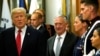 FILE - Secretary of Defense James Mattis, right, escorts U.S. President Donald Trump as he greets military personnel at the Pentagon, July 20, 2017. 