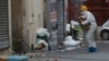 FILE - A police officer enters the building where a raid occurred in Saint-Denis, France, a few days after terrorist attacks in Paris, Nov. 19, 2015. France's prime minister warned at the time that terrorists might at some point use chemical or biological weapons.