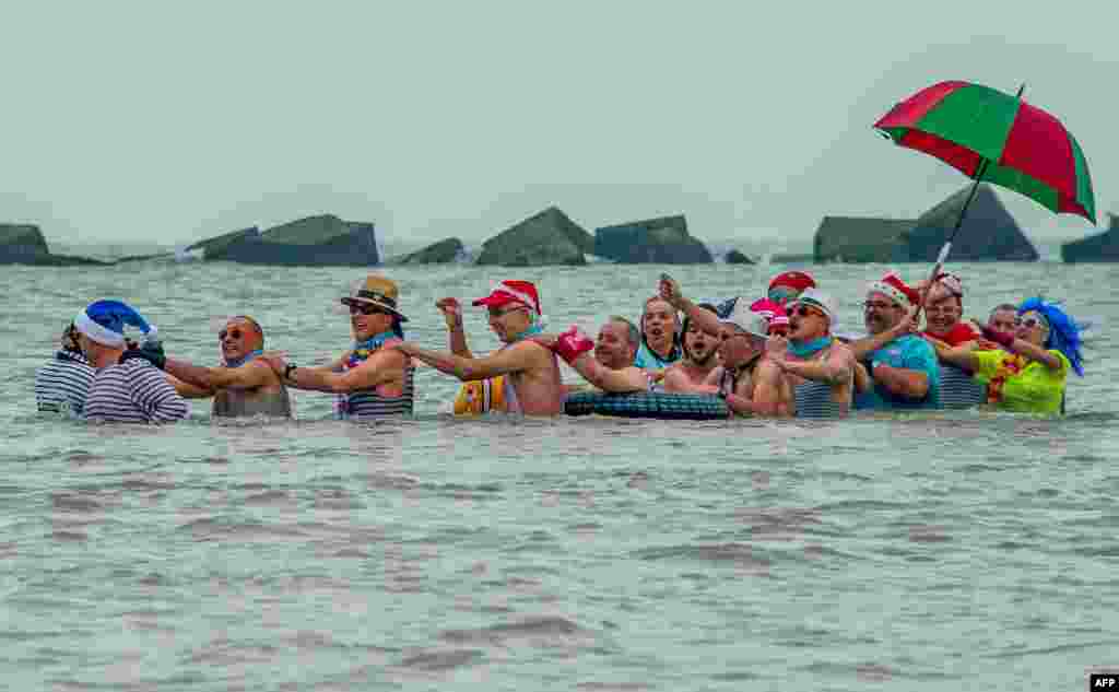People take part in the traditionnal sea bath as part of the New Year's celebrations at Malo-Les-Bains beach in Dunkirk, northern France.
