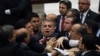 FILE - Ruling Justice and Development Party lawmakers and members of the Republican People's Party skirmish during debate on corruption charges against ministers in the cabinet of then-Prime Minister Recep Tayyip Erdogan in Ankara, Turkey, May 5, 2014.