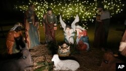 A Nativity scene is illuminated by a Christmas tree on Payrow Plaza in Bethlehem, Pennsylvania, known as 'Christmas City, USA,' Dec. 1, 2024.